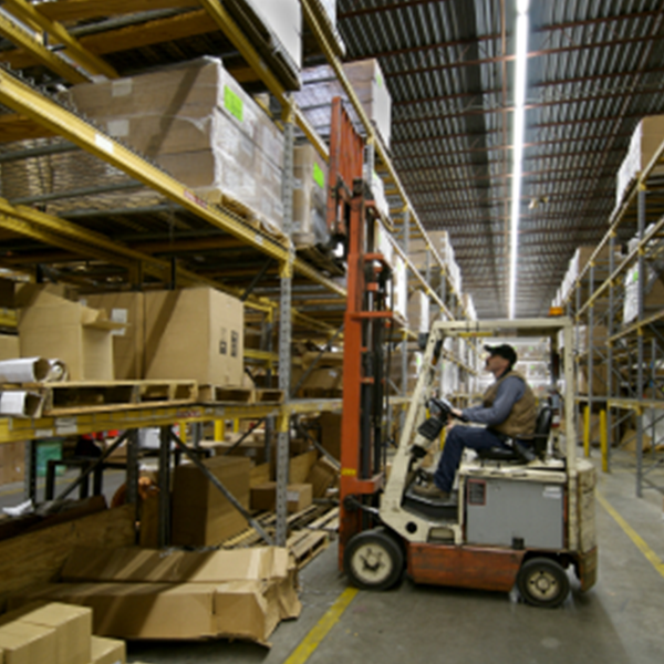man operating a forklift in a storage facility